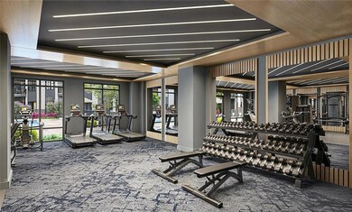 Exercise room with carpet and a tray ceiling