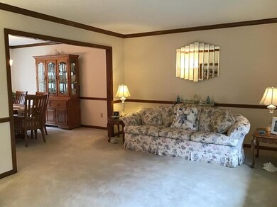 Living room with chair rail and crown moldings.
