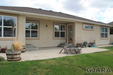 This covered rear patio does double duty, providin