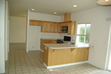 Open kitchen with eating bar, pantry and built-in desk. 