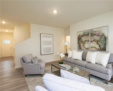 Living room with wood finished floors and recessed lighting