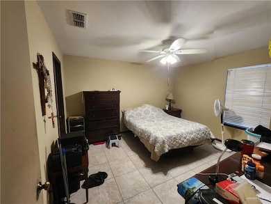 Bedroom featuring light tile patterned floors and a ceiling fan