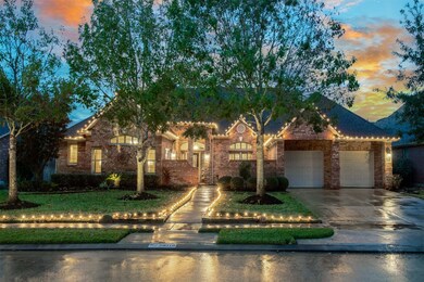 Beautiful brick facade & landscape lighting grace the front of this home. The additional holiday lights make this home shine!