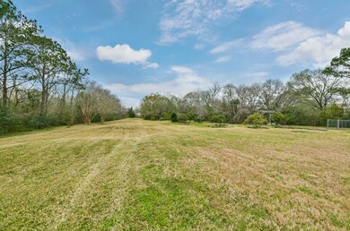 Tucked along the far western property line and bordered to the north by the banks of the meandering Cowart Creek, this cleared space has been transformed into a manicured 2-hole golf lane with lush grass and bordered on either side by towering trees.