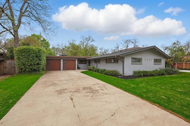 View of front of property with driveway, an attach