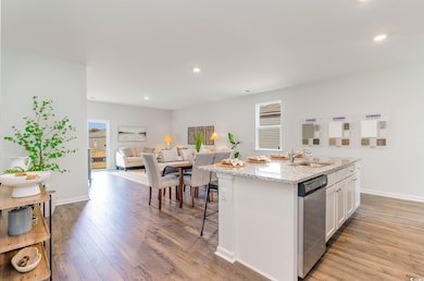 Kitchen with light wood-type flooring, an island w