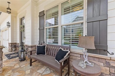 Covered front porch  with flagstone patio is the p