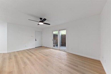 Bright, spacious room with light wood flooring, wh