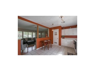 Open kitchen with tile floors.