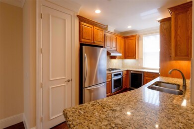 Kitchen featuring light stone countertops, beverag