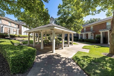 View of community featuring a gazebo, a pergola, and a yard