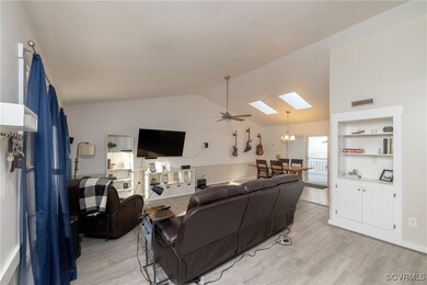 Living room with vaulted ceilings and skylights!