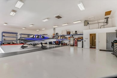 Garage featuring white fridge
