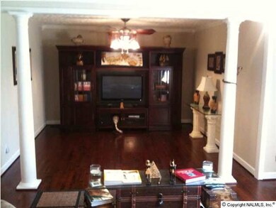 Dining room features two fashionable columns and new lighting. Could be utilized as an extended great room.