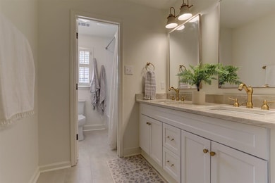 Full bath featuring double vanity and a shower with curtain