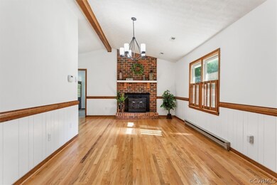 Fireplace with Woodstove, freshly painted, and newly refinished hardwood floors, vaulted ceiling