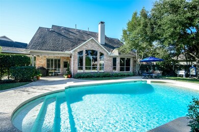 Covered patio and walkway to garage. Plenty of space around the pool for entertaining.
