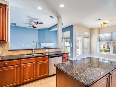 Kitchen featuring brown cabinets, a sink, visible