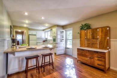 Kitchen breakfast bar & door to back patio.