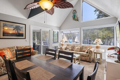 Sunroom with ceiling fan and vaulted ceiling