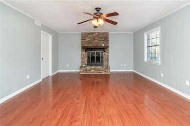 Unfurnished living room featuring wood-type floori