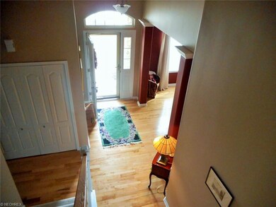 Looking down from second story stairs towards foye