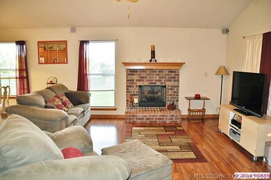 FIREPLACE IN LIVING WITH LOTS OF LIGHT