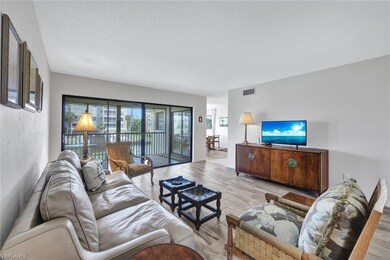 Living room featuring light wood-type flooring and a textured ceiling