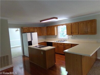 Kitchen. The kitchen is very spacious and has a lot of counter space.  The island has a down draft Jenn-air stove with grill.