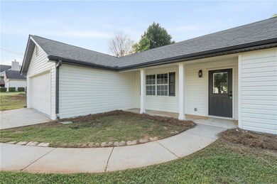 Doorway to property featuring an attached garage, 