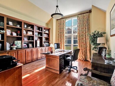 First floor office and built in bookcases & cabinet space! Cathedral ceiling, hardwood floors and wall to ceiling window facing the front of the home.