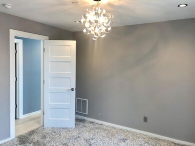 Bedroom with Modern Light Fixture