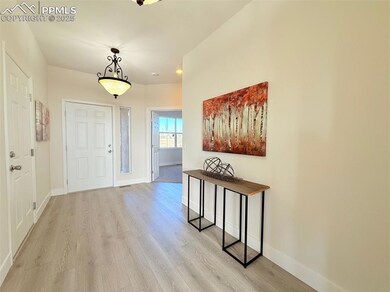 Entryway featuring baseboards and light wood-style floors
