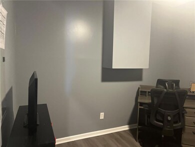 Office with baseboards and wood finished floors