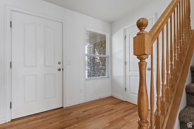 Entrance foyer featuring stairs and hard wood floors