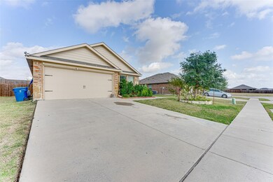 Ranch-style home with brick siding, an attached ga