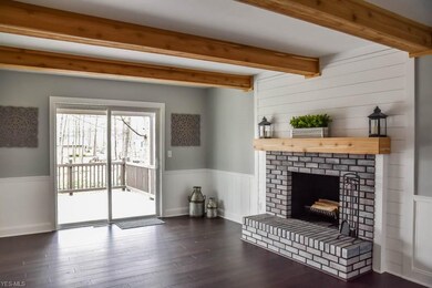 Family room with a brick fireplace, natural wood m