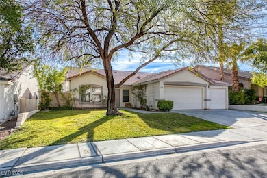 Front of home with large shade tree and real grass
