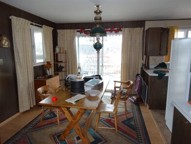 Large dining area coming in from the garage. and opening onto the deck.