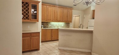 Kitchen with white fridge, tasteful backsplash, a 