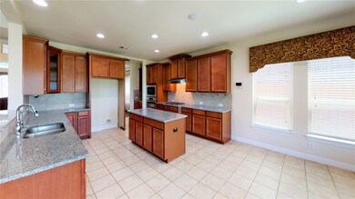 Kitchen has plenty of cabinets and counter space.