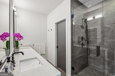 Upstairs, the Spacious Primary Suite feels like a High-End Hotel Escape, featuring a Wall of Windows, Large Walk-In Closet, and a Spa-Inspired Bathroom with Stone Double Vanity, Glass-Enclosed Shower, and Designer Finishes.