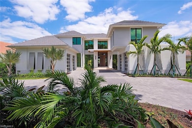 View of front of home with driveway and stucco siding