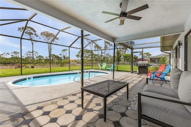 Swimming pool with a patio area, ceiling fan, gril
