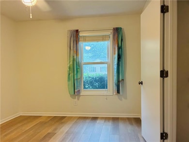 Empty room with wood finished floors and baseboards