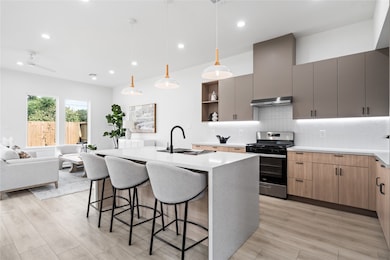 This stunning kitchen features a seamless flow into the living room, creating the perfect space for both everyday living and entertaining. With its modern farmhouse charm and Scandinavian-inspired design, it balances warmth and functionality beautifully. Imagine preparing meals while staying connected to family and guests in this open, inviting layout.