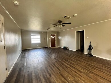 Unfurnished living room with baseboards, crown mol