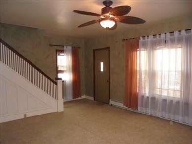 Very large living room.  Window treatments through
