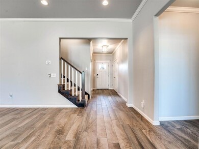 Entryway with wood-type flooring and ornamental mo