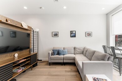 Living area with recessed lighting, visible vents